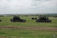 AS-90 guns in the foreground and MLRS in the background at Larkhill, photo by D. Hawkins