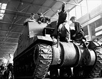 “Workmen on the assembly line complete the final stages of installing a gun on a locomotive tank in the Montreal Locomotive Works plant” - vehicle is a Sexton self-propelled gun