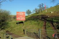 No Go Area: The sign with the red flag flying at the entrance to the Sennybridge military training area effectively means no access to the upper Nant Bran valley today, photo and caption by D. Pinnieger